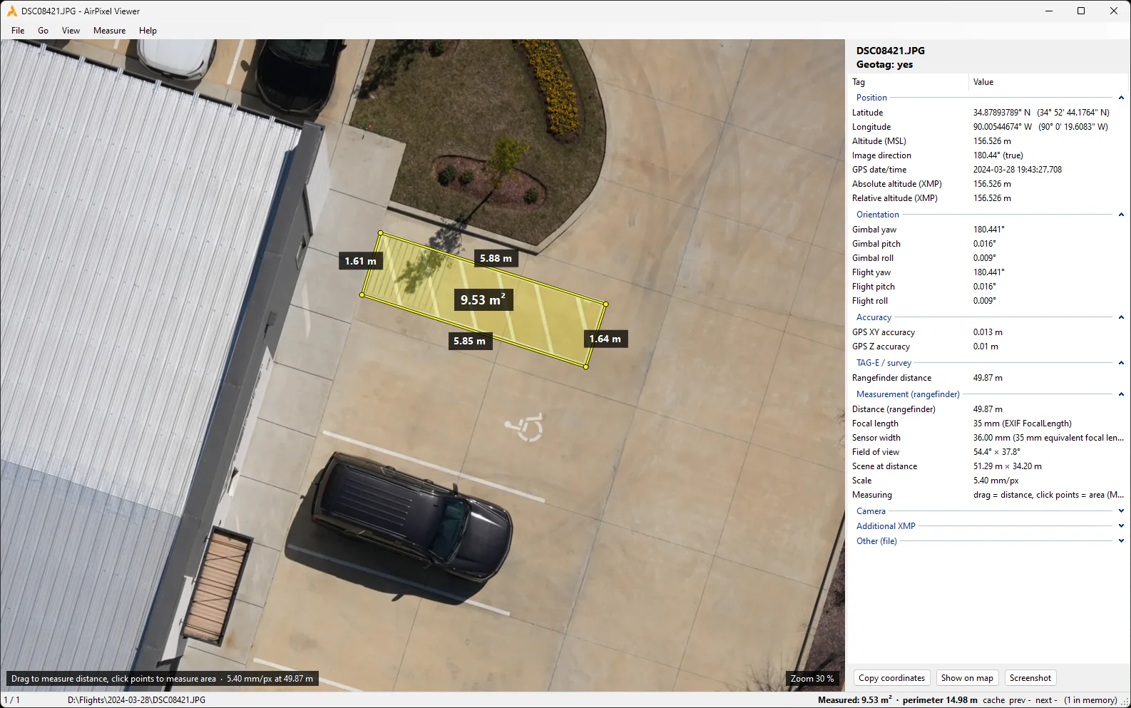 AirPixel Viewer window: an aerial photo of a car park with the hatched access aisle outlined in yellow, 9.53 square metres, each edge labelled with its length, and the geotag panel listing position, orientation, accuracy and rangefinder data